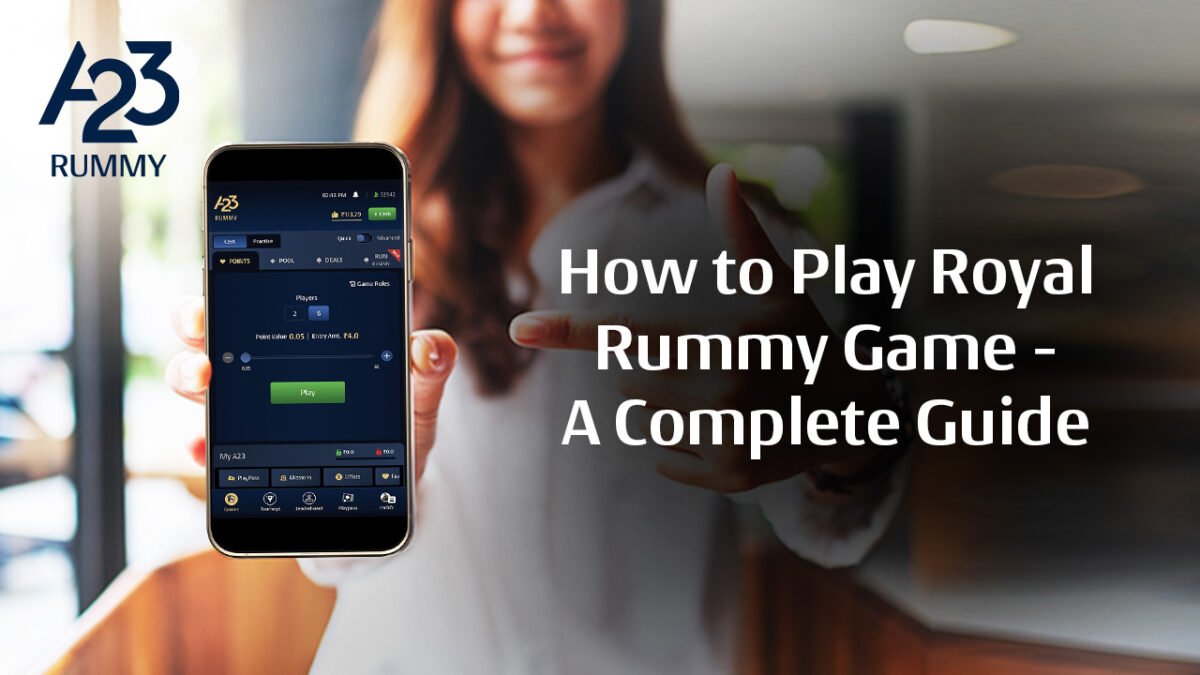 A23 rummy banner image where a woman is showing the A23 rummy app dashboard on her mobile device by pointing at it with a finger in the background and how to play royal rummy game: A complete guide as a write-upon the image